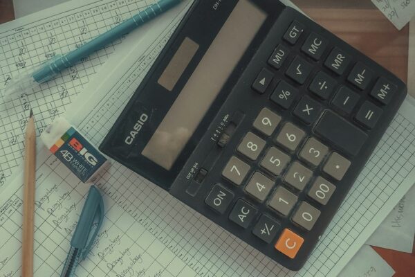 Calculator sitting on a pile of financial papers