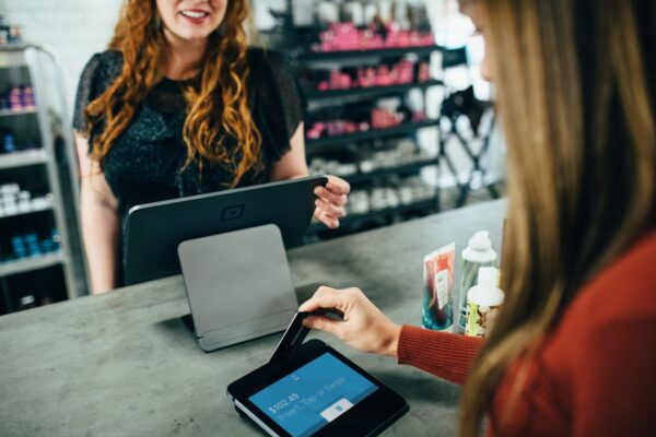 Customer paying at a retail store checkout counter