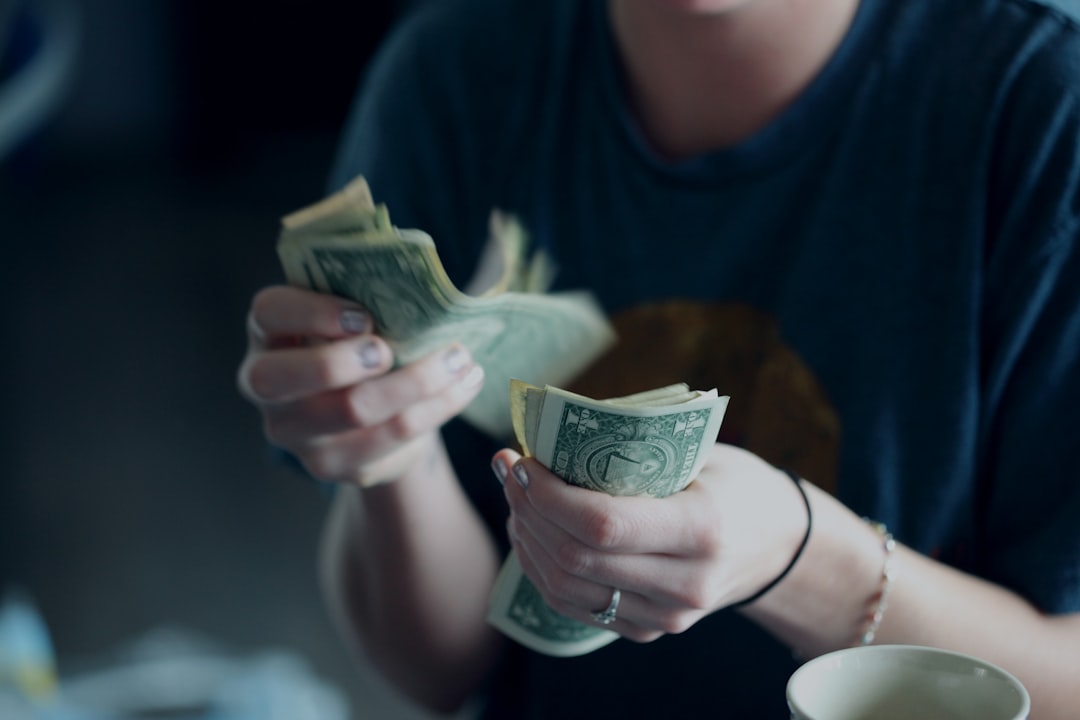 Person counting cash banknotes