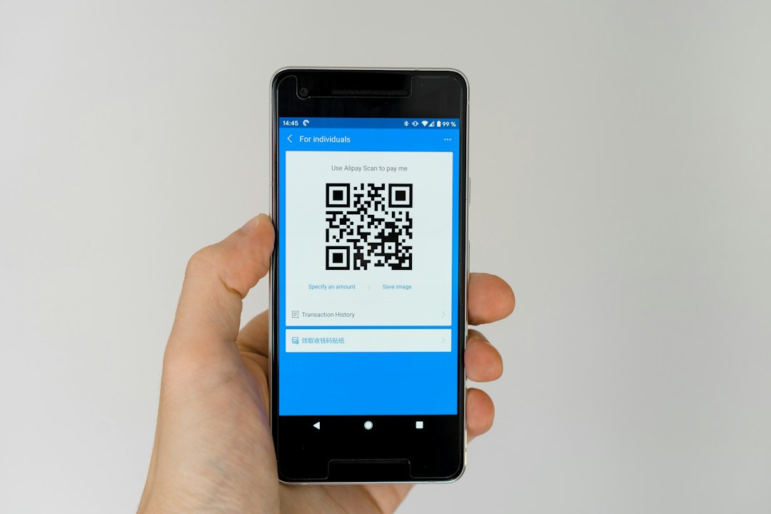 Smartphone displaying a QR code for payment verification
